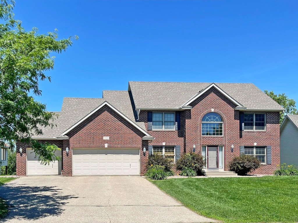 3599 Clare Downs Path, Rosemount, MN 55068 - colonial inspired home with an attached garage, concrete driveway, a front lawn, brick siding, and roof with shingles