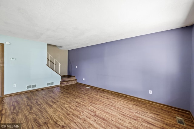 1111 Royal Oaks Dr, Shoreview, MN 55126 - unfurnished living room featuring wood finished floors and stairway