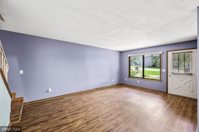 1111 Royal Oaks Dr, Shoreview, MN 55126 - unfurnished living room with wood finished floors, a textured ceiling, and stairs