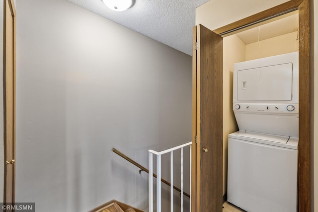 1111 Royal Oaks Dr, Shoreview, MN 55126 - laundry room with stacked washer and clothes dryer and a textured ceiling