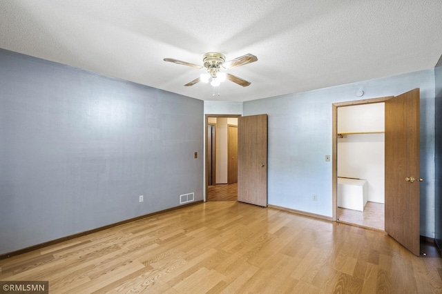 1111 Royal Oaks Dr, Shoreview, MN 55126 - unfurnished bedroom featuring light wood-type flooring, a ceiling fan, and a textured ceiling