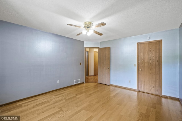 1111 Royal Oaks Dr, Shoreview, MN 55126 - unfurnished bedroom with wood finished floors, a textured ceiling, and a ceiling fan