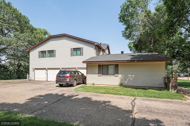 1111 Royal Oaks Dr, Shoreview, MN 55126 - view of front of home featuring driveway, an attached garage, and roof with shingles