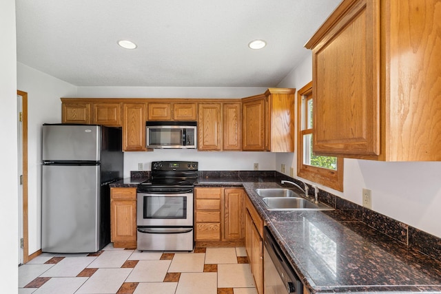 5071 Arrowood Ln N, Plymouth, MN 55442 - kitchen with stainless steel appliances, brown cabinetry, recessed lighting, and dark stone counters