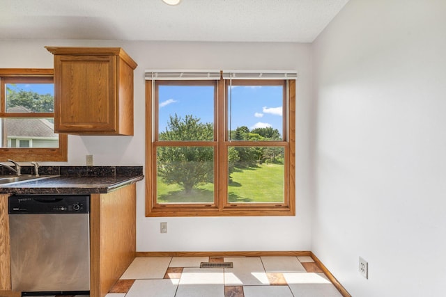 5071 Arrowood Ln N, Plymouth, MN 55442 - kitchen with stainless steel dishwasher, dark countertops, and brown cabinetry
