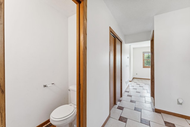 5071 Arrowood Ln N, Plymouth, MN 55442 - bathroom featuring toilet and baseboards