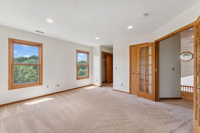 5071 Arrowood Ln N, Plymouth, MN 55442 - carpeted empty room with a smoke detector, recessed lighting, french doors, and a textured ceiling