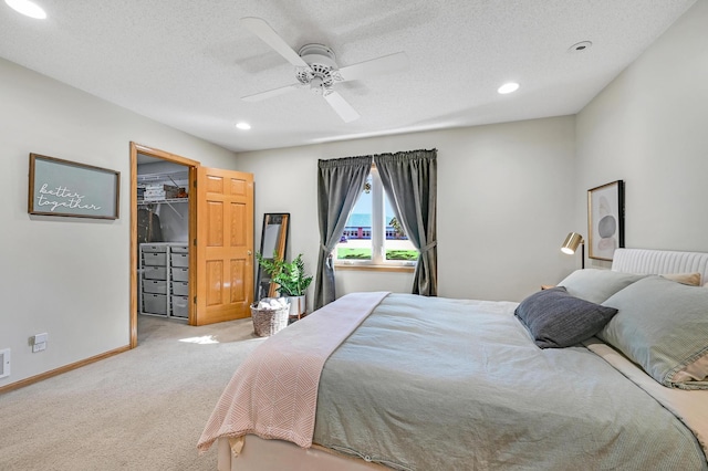 7111 Trenton Ln N, Maple Grove, MN 55369 - bedroom with light carpet, a spacious closet, recessed lighting, ceiling fan, and a textured ceiling