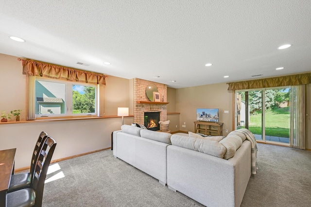 7111 Trenton Ln N, Maple Grove, MN 55369 - carpeted living room with recessed lighting, a fireplace, a textured ceiling, and plenty of natural light