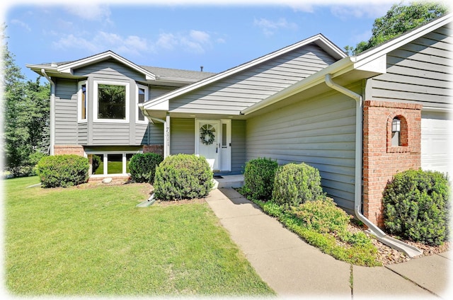 7111 Trenton Ln N, Maple Grove, MN 55369 - view of front facade with a front yard, brick siding, and a garage