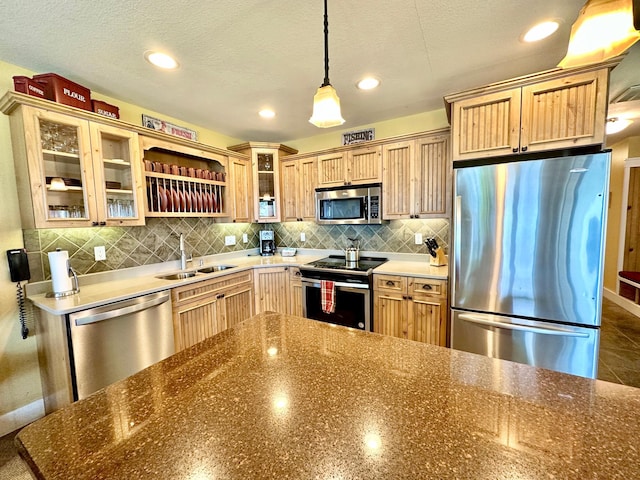 6940 Beach View Ln NW Unit 220-1, Walker, MN 56484 - kitchen featuring stainless steel appliances, decorative backsplash, hanging light fixtures, glass insert cabinets, and a textured ceiling