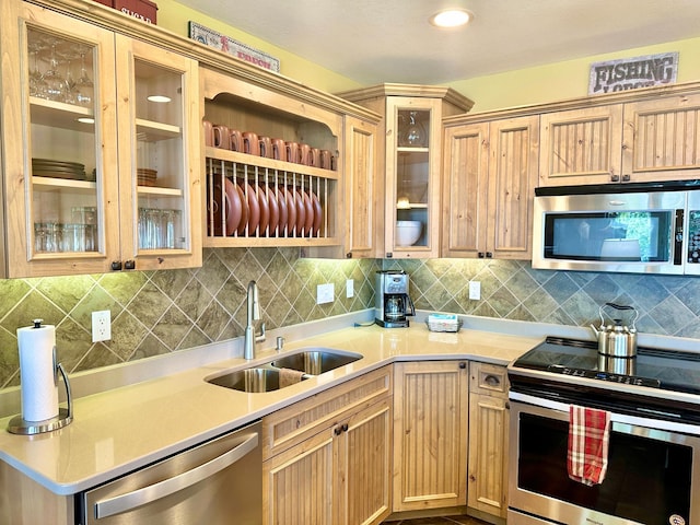 6940 Beach View Ln NW Unit 220-1, Walker, MN 56484 - kitchen with appliances with stainless steel finishes, backsplash, light countertops, light brown cabinets, and recessed lighting