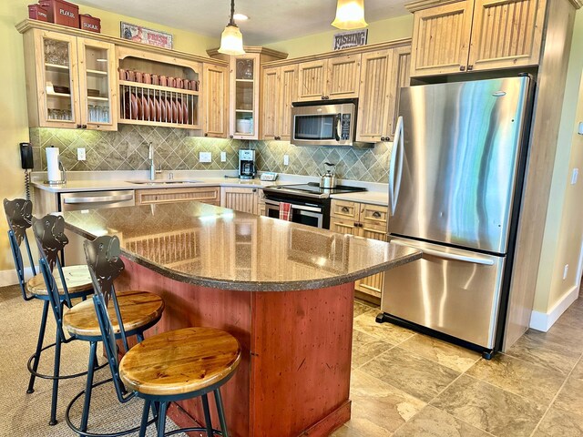 6940 Beach View Ln NW Unit 220-1, Walker, MN 56484 - kitchen featuring appliances with stainless steel finishes, backsplash, a kitchen breakfast bar, decorative light fixtures, and glass insert cabinets