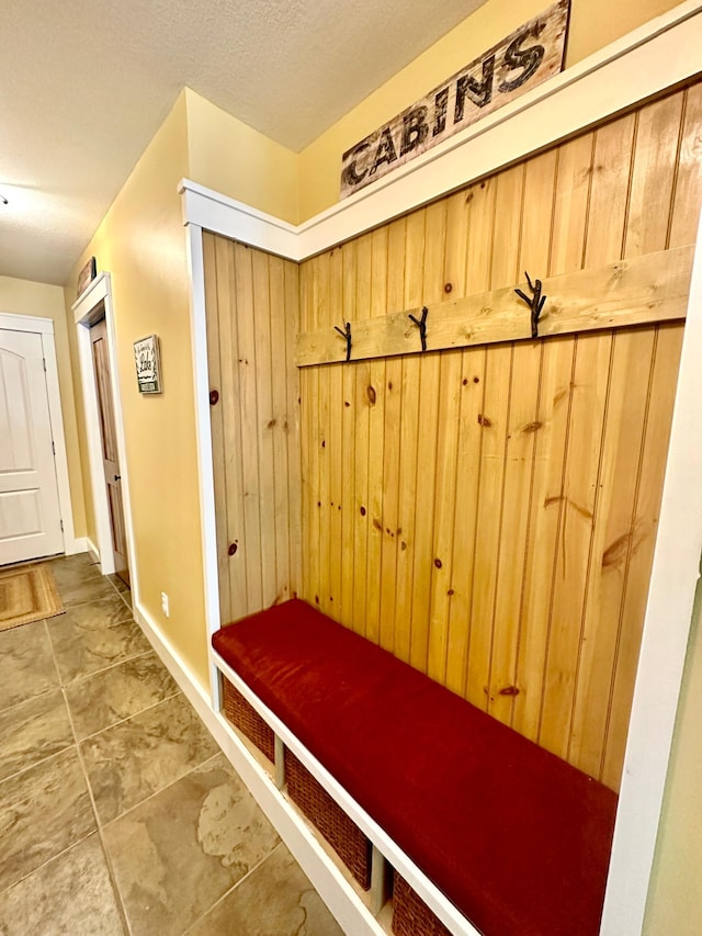 6940 Beach View Ln NW Unit 220-1, Walker, MN 56484 - mudroom featuring a textured ceiling and baseboards