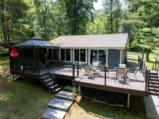 N2590 Warren Rd, Madge Twp, WI 54870 - deck featuring a gazebo, outdoor dining area, and a lawn