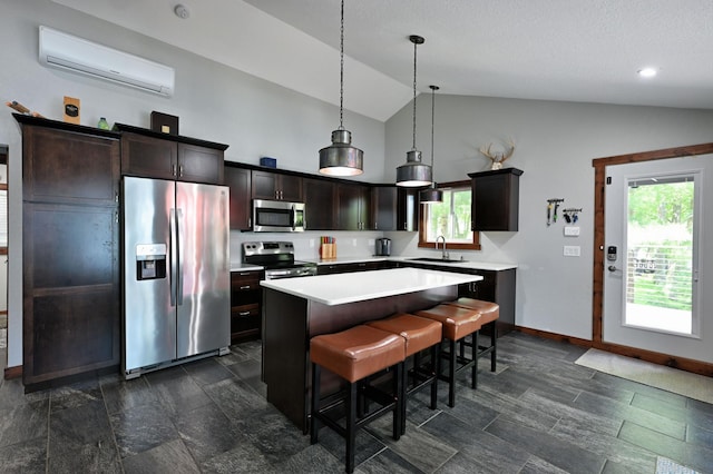 N2590 Warren Rd, Madge Twp, WI 54870 - kitchen featuring appliances with stainless steel finishes, an AC wall unit, plenty of natural light, light countertops, and high vaulted ceiling