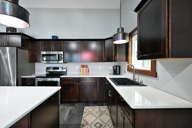 N2590 Warren Rd, Madge Twp, WI 54870 - kitchen featuring stainless steel appliances, decorative light fixtures, dark brown cabinetry, and light stone countertops