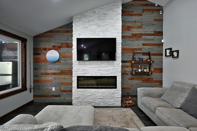 N2590 Warren Rd, Madge Twp, WI 54870 - living room featuring vaulted ceiling, wooden walls, and a fireplace