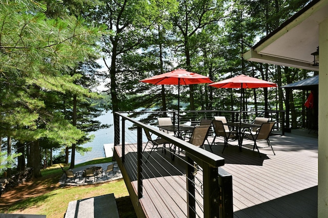 N2590 Warren Rd, Madge Twp, WI 54870 - dock area with outdoor dining space, a deck with water view, and an outdoor fire pit