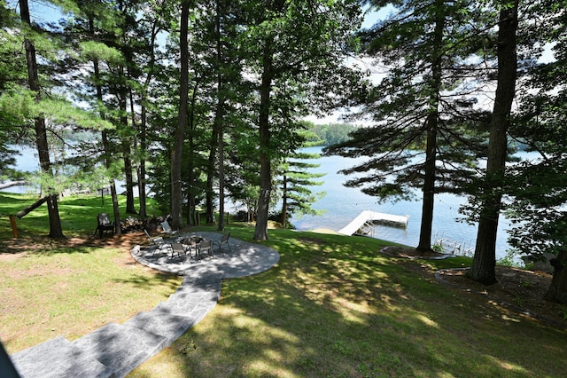 N2590 Warren Rd, Madge Twp, WI 54870 - view of green lawn with a water view, a boat dock, and a patio