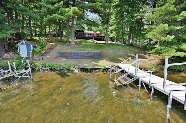 N2590 Warren Rd, Madge Twp, WI 54870 - dock featuring a water view, boat lift, and view of wooded area