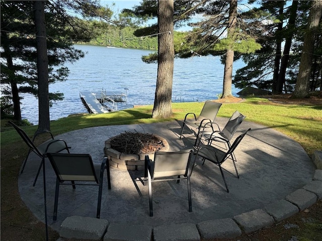 N2590 Warren Rd, Madge Twp, WI 54870 - view of patio / terrace with an outdoor fire pit, a water view, and a boat dock
