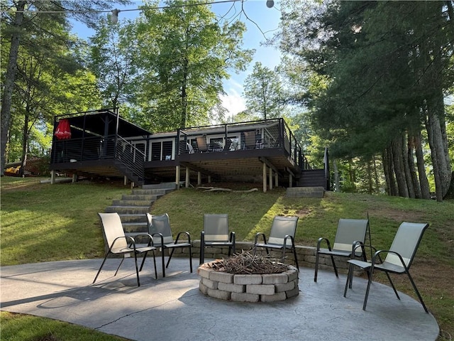 N2590 Warren Rd, Madge Twp, WI 54870 - back of house with stairs, a patio area, a lawn, and an outdoor fire pit