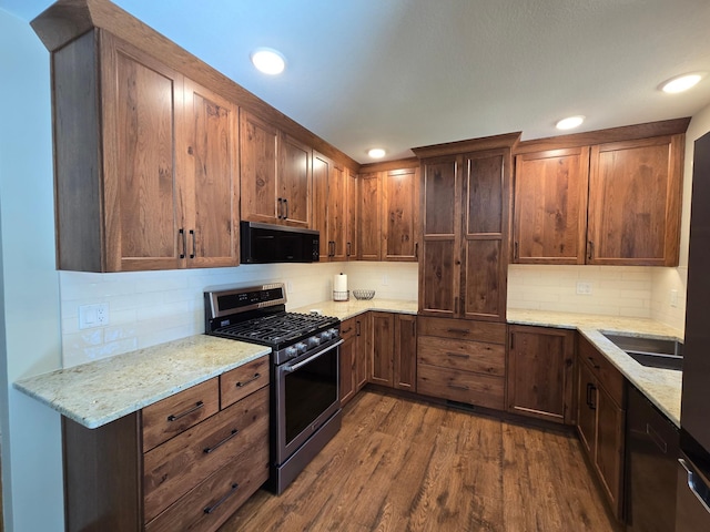 21200 5th St NW, Colfax Twp, MN 56273 - kitchen featuring stainless steel range with gas cooktop, black microwave, dark wood finished floors, decorative backsplash, and light stone countertops
