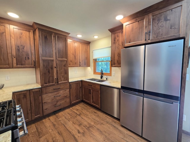21200 5th St NW, Colfax Twp, MN 56273 - kitchen with appliances with stainless steel finishes, dark wood-type flooring, backsplash, recessed lighting, and light stone countertops