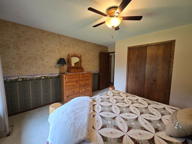 21200 5th St NW, Colfax Twp, MN 56273 - bedroom featuring wallpapered walls, a closet, a ceiling fan, and light colored carpet