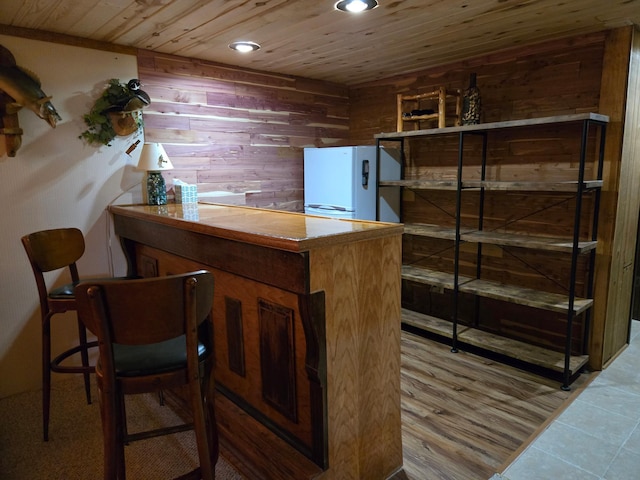 21200 5th St NW, Colfax Twp, MN 56273 - bar area featuring wooden walls, wood ceiling, freestanding refrigerator, and recessed lighting