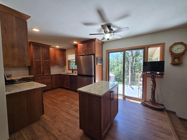 21200 5th St NW, Colfax Twp, MN 56273 - kitchen with stainless steel appliances, ceiling fan, dark wood-style flooring, light stone counters, and recessed lighting