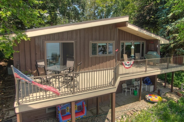 13235 80th St NW, Annandale, MN 55302 - rear view of property with outdoor dining area and a wooden deck