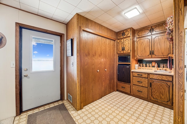 13235 80th St NW, Annandale, MN 55302 - kitchen featuring oven, black microwave, light countertops, and brown cabinets
