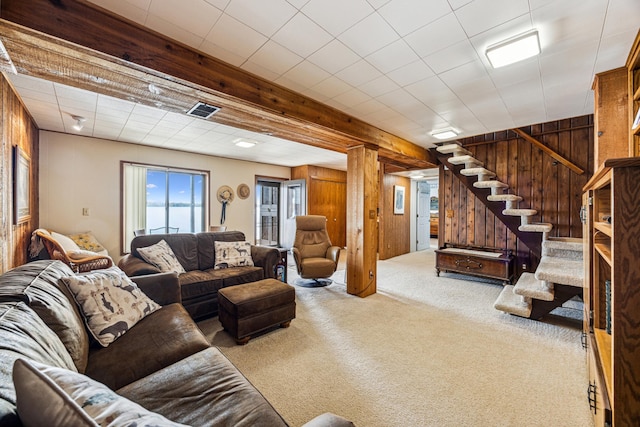 13235 80th St NW, Annandale, MN 55302 - living area featuring carpet flooring, wood walls, and stairs