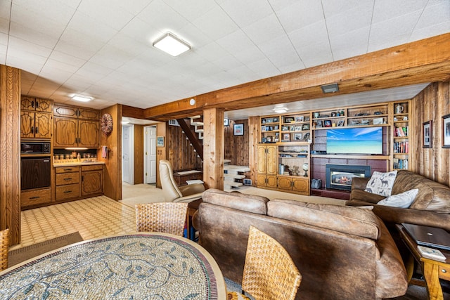13235 80th St NW, Annandale, MN 55302 - living room with wooden walls, stairway, a tile fireplace, and built in features