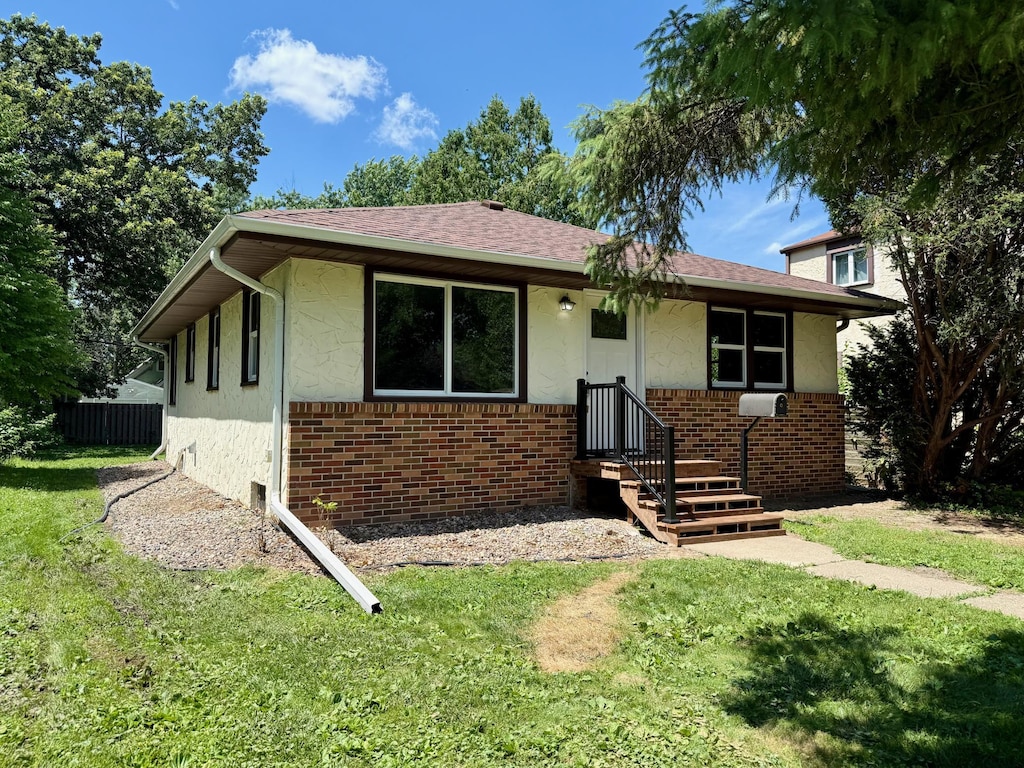 3541 Kyle Ave N, Crystal, MN 55422 - bungalow-style house with brick siding and stucco siding