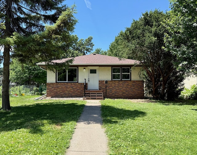 3541 Kyle Ave N, Crystal, MN 55422 - bungalow-style house with brick siding, a front yard, and stucco siding