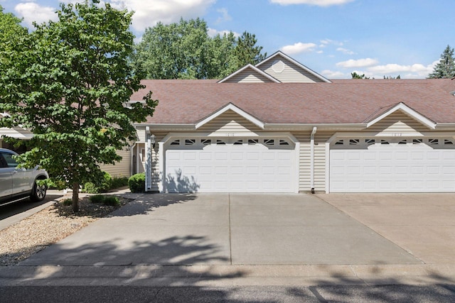 1010 Hill Ct, Shoreview, MN 55126 - view of front of house featuring concrete driveway, an attached garage, and a shingled roof