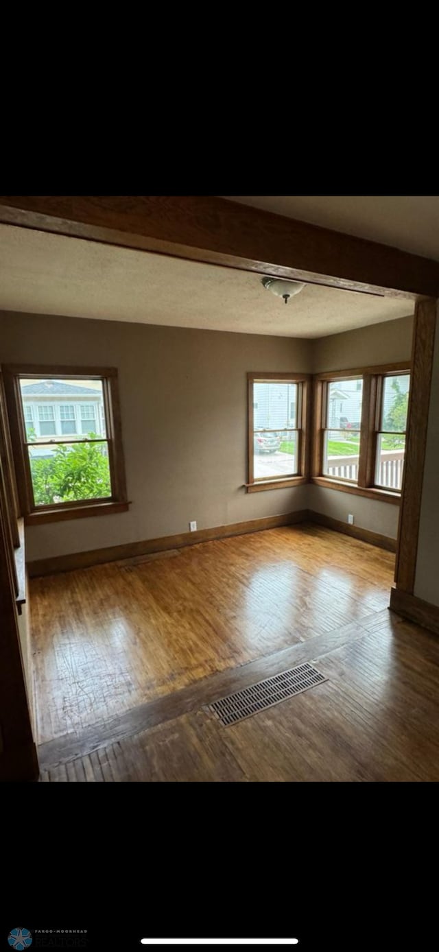 802 11th Ave N, Fargo, ND 58102 - spare room with wood finished floors and baseboards