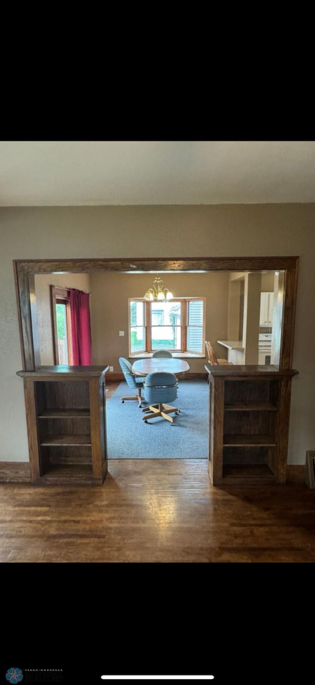 802 11th Ave N, Fargo, ND 58102 - living area featuring healthy amount of natural light, wood finished floors, and a chandelier