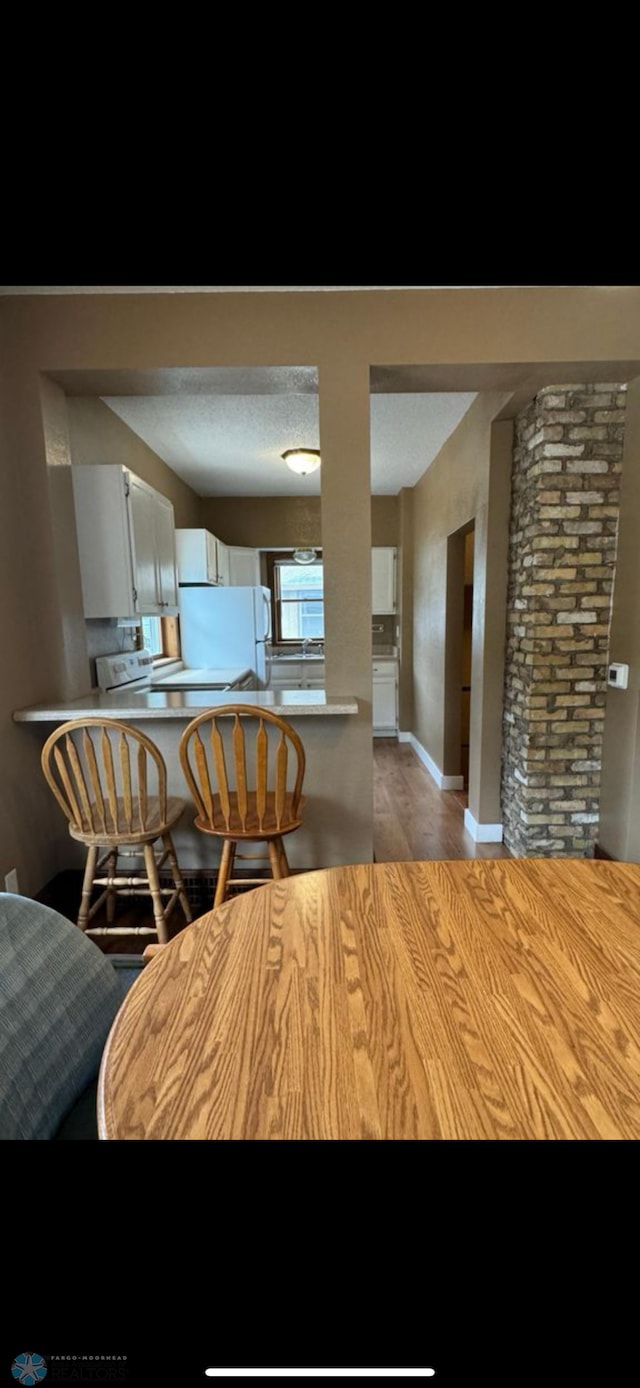 802 11th Ave N, Fargo, ND 58102 - dining space featuring light wood finished floors and baseboards