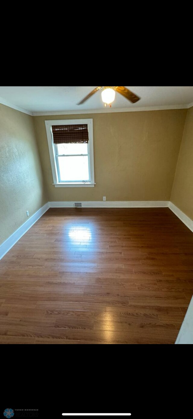 802 11th Ave N, Fargo, ND 58102 - empty room with wood finished floors, crown molding, and ceiling fan