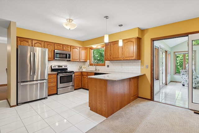 10316 Zinran Ave S, Bloomington, MN 55438 - kitchen with appliances with stainless steel finishes, a peninsula, brown cabinets, and backsplash