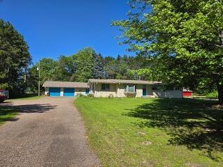 32116 Palm St NW, Bradford Twp, MN 55008 - ranch-style house with a front yard and a garage