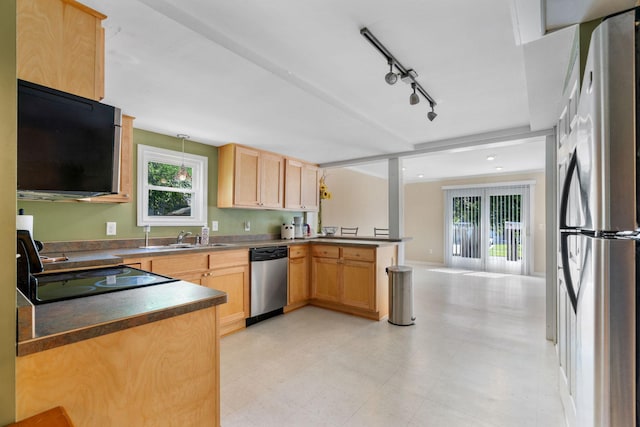 905 Bellows St, West Saint Paul, MN 55118 - kitchen featuring stainless steel appliances, a peninsula, dark countertops, track lighting, and light flooring