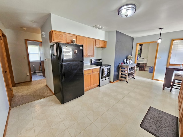 460 3rd St, Bird Island, MN 55310 - kitchen featuring stainless steel electric range, freestanding refrigerator, light countertops, light floors, and decorative light fixtures