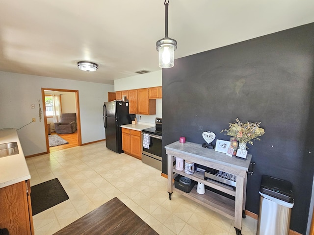 460 3rd St, Bird Island, MN 55310 - kitchen featuring electric stove, freestanding refrigerator, light countertops, brown cabinets, and light floors