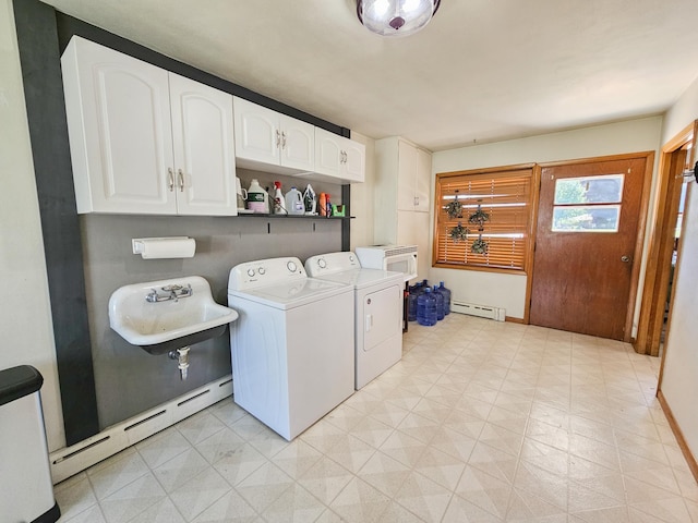 460 3rd St, Bird Island, MN 55310 - washroom featuring washing machine and clothes dryer, a baseboard heating unit, light flooring, and cabinet space