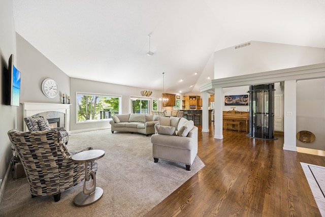 13703 47th St NE, Saint Michael, MN 55376 - living room featuring a fireplace, lofted ceiling, dark wood-type flooring, recessed lighting, and ornate columns